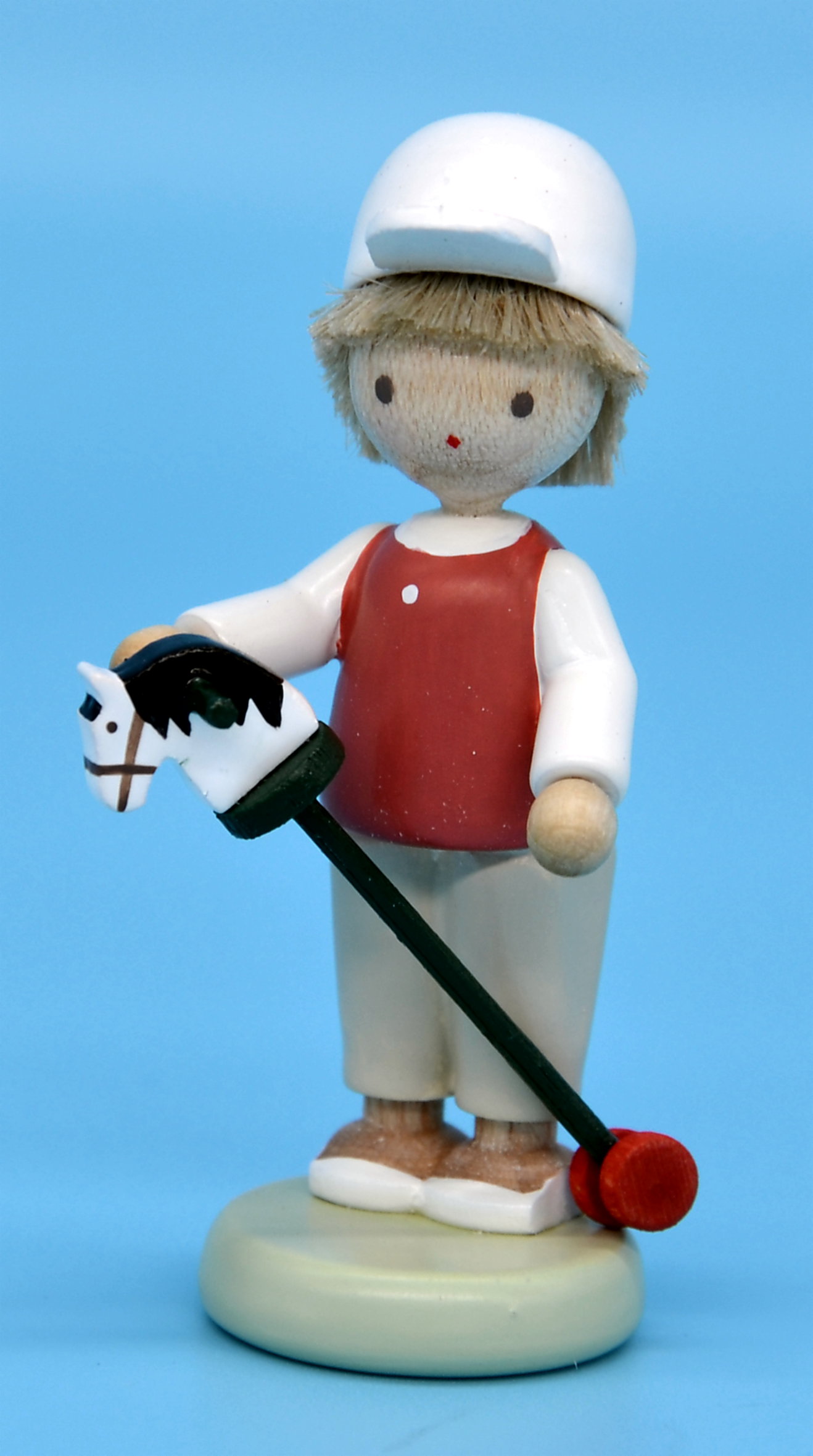 Junge mit Steckenpferd